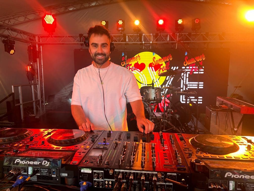 Wedding DJ performing at the decks | Aura providing DJs for weddings in Milton Keynes, Buckingham, Oxford, St Albans, Aylesbury, Bedford, and beyond