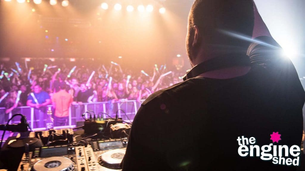 DJ Ashley Tapster entertaining a packed crowd at The Engine Shed from behind the decks.