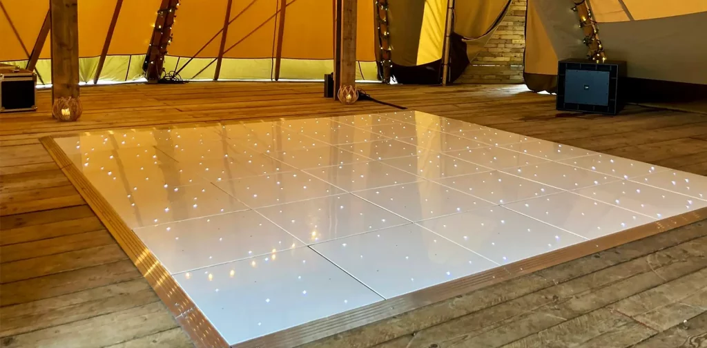 LED dancefloor hire with romantic overhead fairy lights at a luxury Hertfordshire wedding venue.
