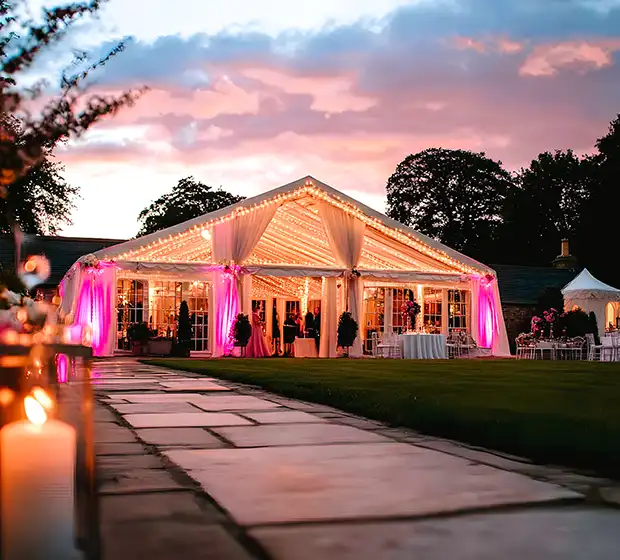 Elegant wedding marquee in Oxfordshire with ambient lighting and dancefloor setup by AURA Wedding DJs.