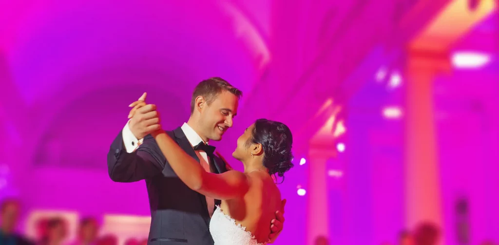 Couple’s first dance with pink uplighting — wedding DJ in Northampton, Northamptonshire.