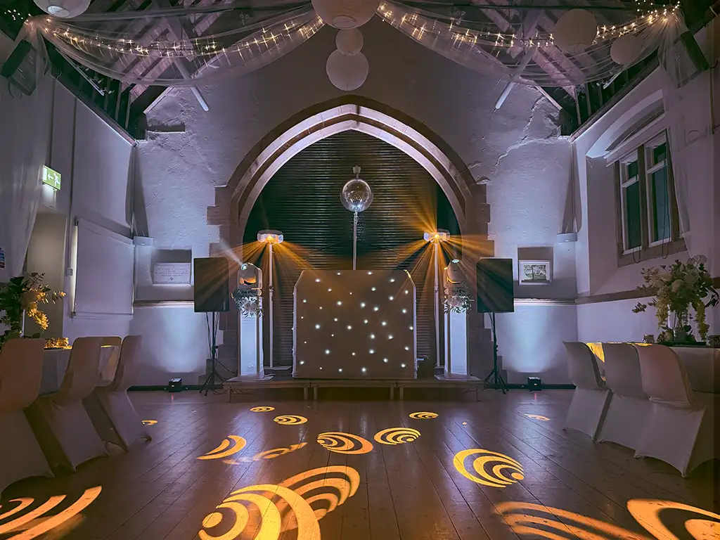 Wedding DJ Bedford with disco lights and modern booth for Bedfordshire weddings