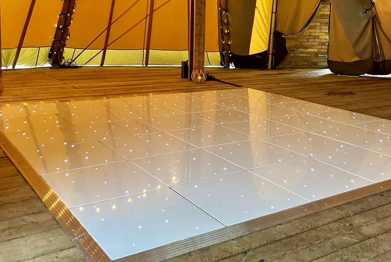 Bride and groom dancing on a white LED starlit wedding dance floor surrounded by guests in Oxford, Milton Keynes, Northampton, Bedford, Hertfordshire and St Albans