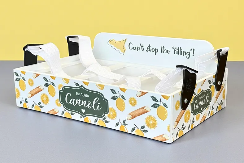 Walking cannoli bar tray from Aura featuring lemon and cannoli design, used for serving freshly filled mini cannoli at weddings.