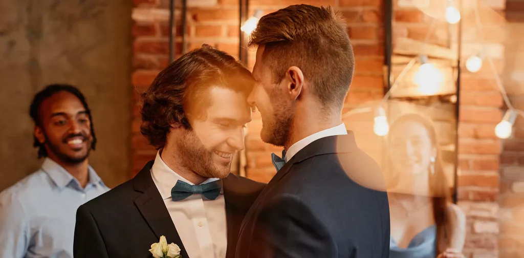 Elegant same-sex couple celebrating their wedding at a Buckinghamshire venue with warm ambient lighting.