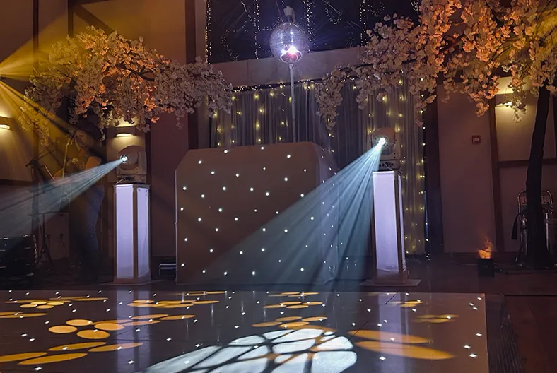 Oxford wedding DJ setup with professional lighting and stylish booth for a wedding reception